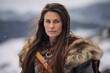 © ekim - Mature viking woman outdoors in winter. She has long brown hair and she is dressed in furs and warm clothing.