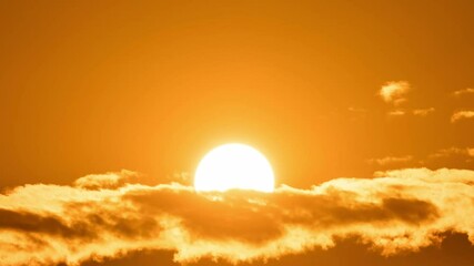 Wall Mural - timelapse of dramatic sunrise with orange sky in a cloudy day.