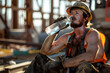 © rhmwhyni - hardworking Caucasian male construction worker drinking water from a bottle, summer