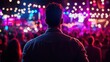 © h4kunA - Man at Outdoor Concert Watching Vibrant Lightshow
