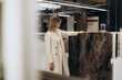© Roman - Woman Examining Marble Slab in a Modern Interior Design Showroom