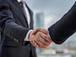 © ideasStock - Two businessmen in suits shaking hands outdoors, symbolizing a successful partnership, trust, and corporate growth with a modern city skyline in the background.