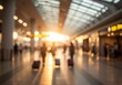 © Hariyanto Bromantio - Blurred airport scene shows travelers with luggage in golden light