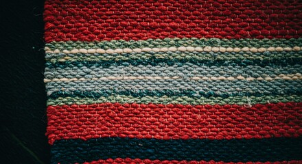 Aufkleber - A red and green striped rug with a black background