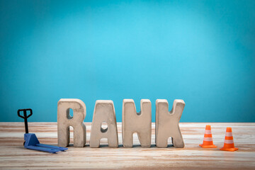 Wall Mural - rank concept. concrete alphabet letters on a light painted wood texture background