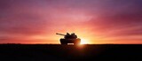 Tank silhouetted against a fiery sunset