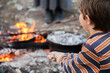© Austockphoto - Young boy toasting a marshmallow on a campfire