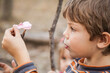 © Austockphoto - Young boy eating a toasted marshmallow from a stick