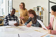 © Mediaphotos - Students engaging in collaborative learning, discussing foreign language materials in a classroom setting. Multiracial group studying together, fostering diverse and inclusive environment
