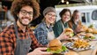 © mlangsen - Smiling food truck staff with burgers and fries