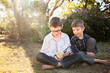 © Austockphoto - Two happy young boys holding fluffy yellow chicks in the backyard