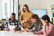© Mediaphotos - Group of diverse students engaging in language study sessions in classroom setting, collaborating and discussing. Bright, interactive environment fostering learning and teacher support