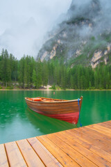 Wall Mural - boat on lake braies, dolomites, italy. lake and reflections on the water surface. mountain landscape