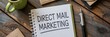 © mediastok.ai - Direct mail marketing plan written in a notebook.