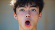 © Eva - Young person with shocked expression and open mouth reacts to unbelievable news.