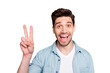 © deagreez - Portrait of cheerful crazy excited overjoyed man having noticed his old acquintance and saying hi to him by showing v-sign isolated over green vivid color background