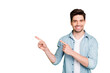 © deagreez - Photo of amazing salesman guy in excited mood indicating finger to empty space advising cool shopping prices wear casual denim shirt isolated green color background