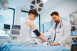 © Halfpoint - Teen boy undergoing medical checkup with doctor in hospital room.