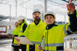 © Halfpoint - Team of engineers and construction workers inspecting building progress.