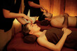 © InfiniteFlow - Couple customer enjoying relaxing anti-stress head massage and pampering facial beauty skin recreation leisure in warm candle lighting ambient salon spa in luxury resort or hotel. Quiescent