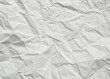 © Cuteart009 - Crumpled white paper texture on a clean, blank surface, featuring wrinkles against a white background.