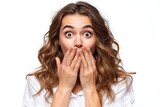 A surprised young woman covering her mouth with both hands, isolated on a diffrent collers or white background, expressing shock and surprise.