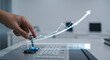 © SashaMagic - Hand pushing lever on keyboard with rising graph overlay.