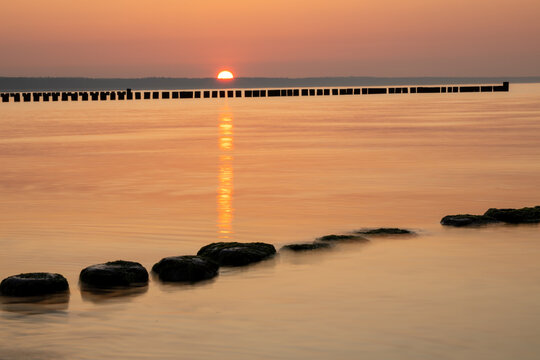 breakwater line in the Baltic Sea at sunset
