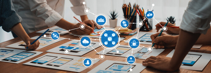 Leinwandbilder - Engaging collaborative session showcasing diverse professionals brainstorming design concepts with smartphones and creative tools laid out on a wooden table. Amity