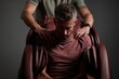 © whitestorm - A man receiving a relaxing shoulder massage from a therapist while sitting in a brown leather massage chair, showcasing a tranquil moment and self-care.