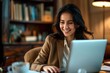 © Aleksandra - professional woman working on laptop in cozy office setting with warm lighting and bookshelves in background