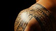 © Atthapon - A man's arm has a tattoo of a tribal design
