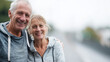 © Frenza - professional portrait photoshoot of a fit and gorgeous elderly European couple are running, smiling confidently, slight sweat on their faces from jogging, wearing elegant sportswear