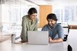 © fizkes - Two Indian smiling workmates working on joint task using laptop, review documents, go through reports, presentations, or proposals together, laughing, enjoy online content, brainstorm creative ideas
