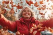 © Nadezhda Bolotina - Middle-aged woman enjoying autumn in a park while throwing leaves in the air