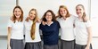 © Rawpixel.com - Group of young girls in school uniforms smiling in a classroom. They are wearing white shirts and gray skirts, standing together in front of a whiteboard. Teenage girls in international high school.