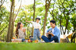 © Prathankarnpap - Happy family enjoying music and fun together at a campsite