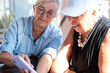 © luciano - Two elderly women joyfully sharing a moment looking at a smartphone together. Their expressions convey happiness, friendship, positivity and companionship, staying connected in the digital age