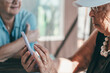 © luciano - Two blurred elderly women sharing a moment looking at smartphone together.  Friendship, positivity and companionship, couple of senior ladies staying connected in the digital age