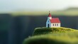 © Ishika - Miniature church on grassy hill