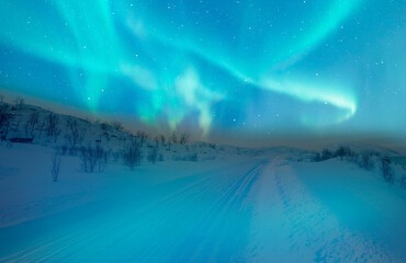Wall Mural - beautiful winter landscape with snow and ice covered road - northern lights (aurora borealis) in the