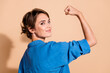 © deagreez - Photo portrait of pretty young girl show flexing muscles wear trendy blue outfit isolated on beige color background