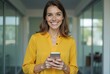 © Alvin - Smiling-Woman-Holding-Smartphone-Yellow-Shirt