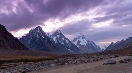 Aufkleber - Majestic mountain summits stand illuminated by dusk, revealing a remote Himalayan landscape with gentle clouds drifting across the twilight sky