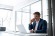 © Stock 4 You - Mature financial specialist, investor entrepreneur man talking on cellphone telephone looking at laptop pc. Smiling male ceo businessman having call with business consultant using computer in office