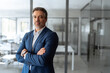 © Stock 4 You - Executive confident senior business coach man specialist looking at camera. Portrait of mature professional boss, leader, ceo, male bank manager businessman in suit standing in office. Copy space