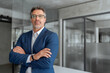 © Stock 4 You - Executive confident senior business man specialist looking at camera. Portrait of mature professional boss, leader, ceo, male bank manager businessman in suit standing in office workplace. Copy space
