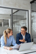 © Stock 4 You - Two partners, colleagues, team of professional finance specialist business people working together. Mature mentor senior leader man, young woman manager discussing project sitting in office. Vertical