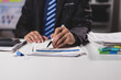 © Wasan - Businessman working on financial documents in the office, accounting, auditing and business investment budget planning.