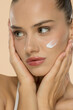 © vladimirfloyd - Close-up portrait of woman with white skincare cream, showcasing natural beauty and glowing complexion